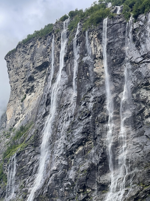 Tall waterfalls cascading down steep rocky cliffs.
