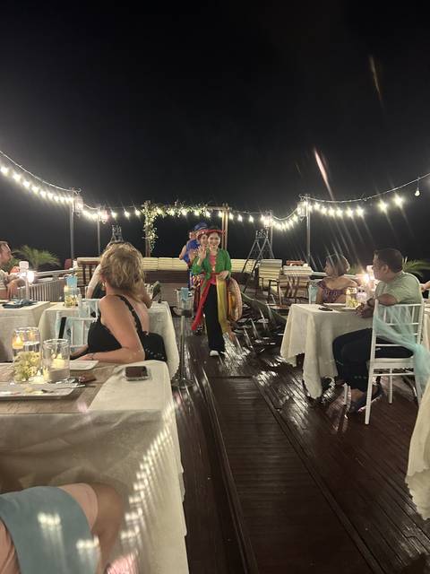 Performance on a dinner cruise deck at night.