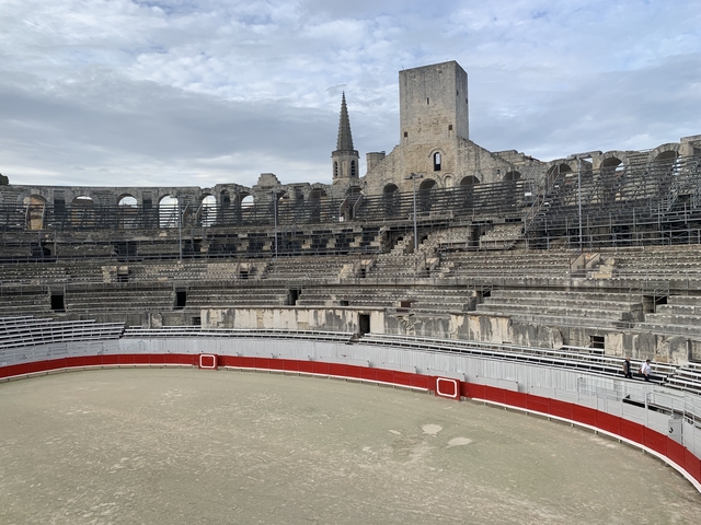 Amphitheater with a spire in the background.