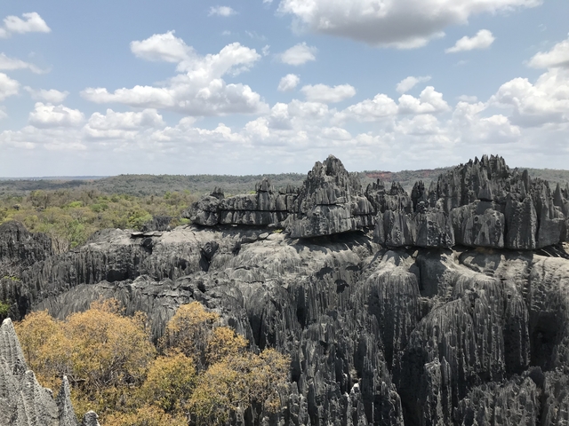 Unique rock formations under a cloudy sky.