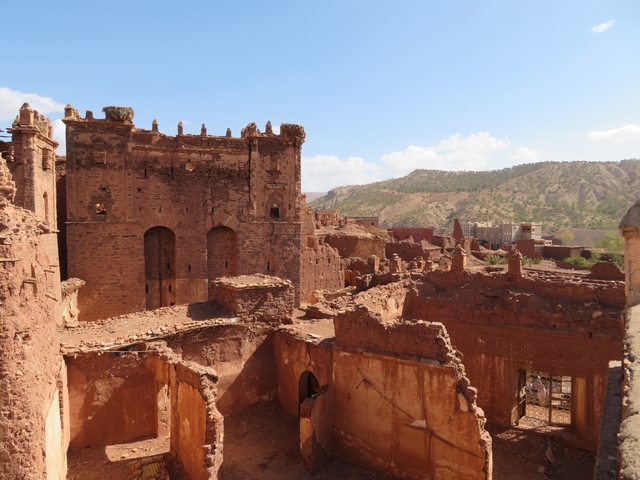       Ruins of an ancient structure set against a hillside in Morocco.
  