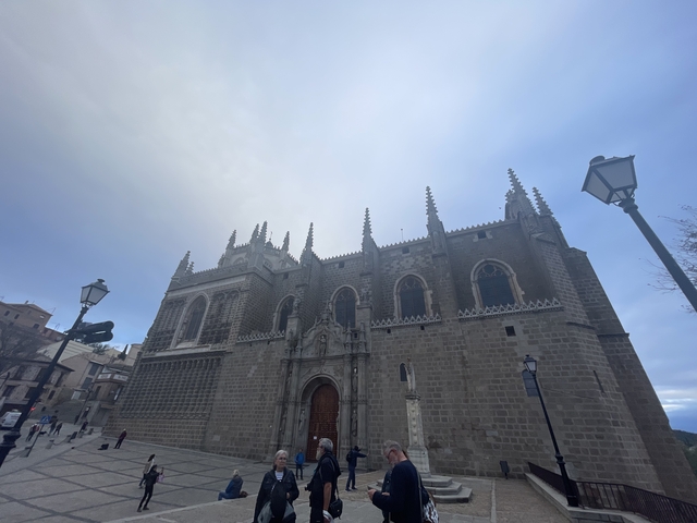 Gothic-style church building against a cloudy sky.