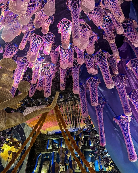 Hanging purple decorative installations indoors.