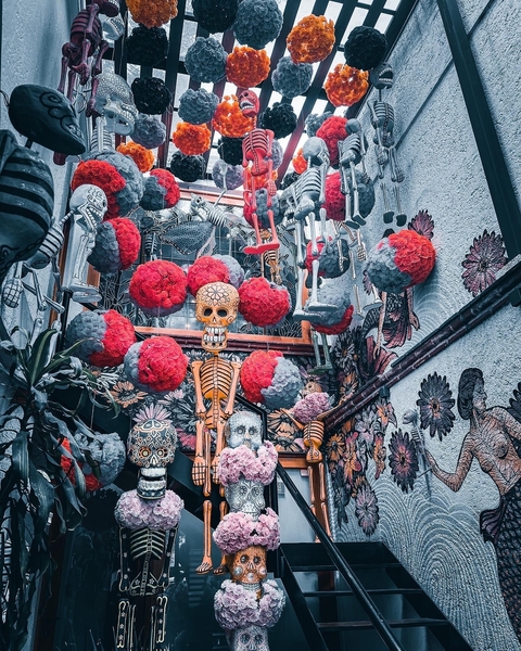 Decorative skeletons and colorful floral hanging sculptures.