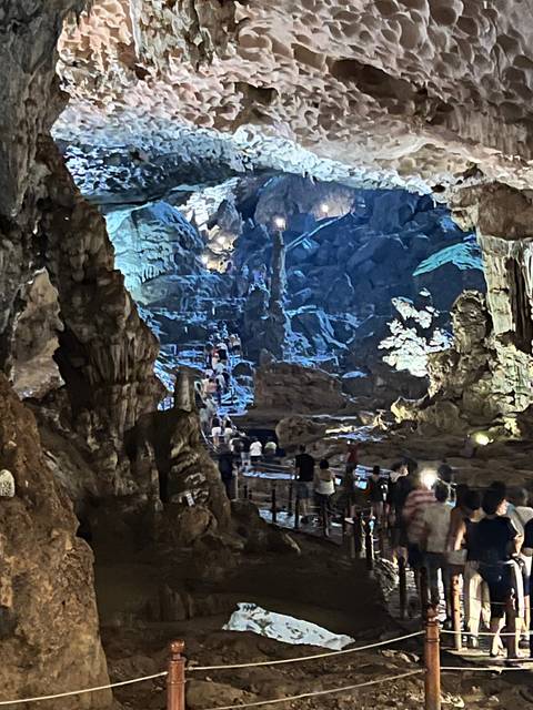 Interior of a cave with tourists exploring.