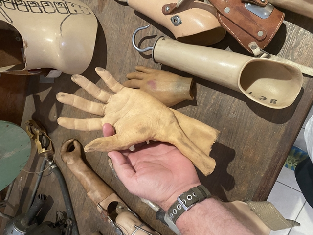       Collection of prosthetic limbs displayed on a table.
  