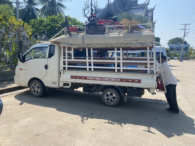       Vehicle labeled 'Tiger Trail' with loaded items at a parking area.
  