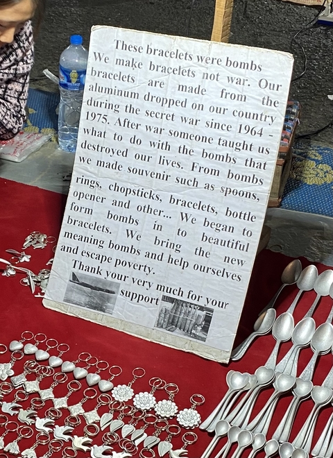 Informational sign about repurposing bombs into souvenirs.