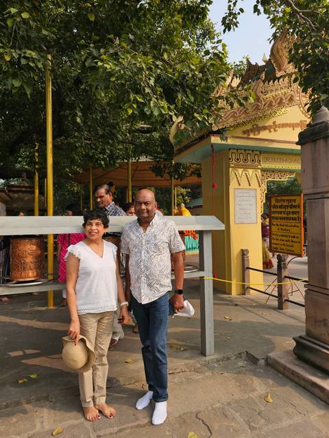 Couple posing at a temple entrance.