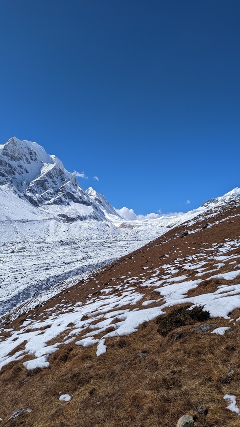 Snow-covered mountains under a clear blue sky.