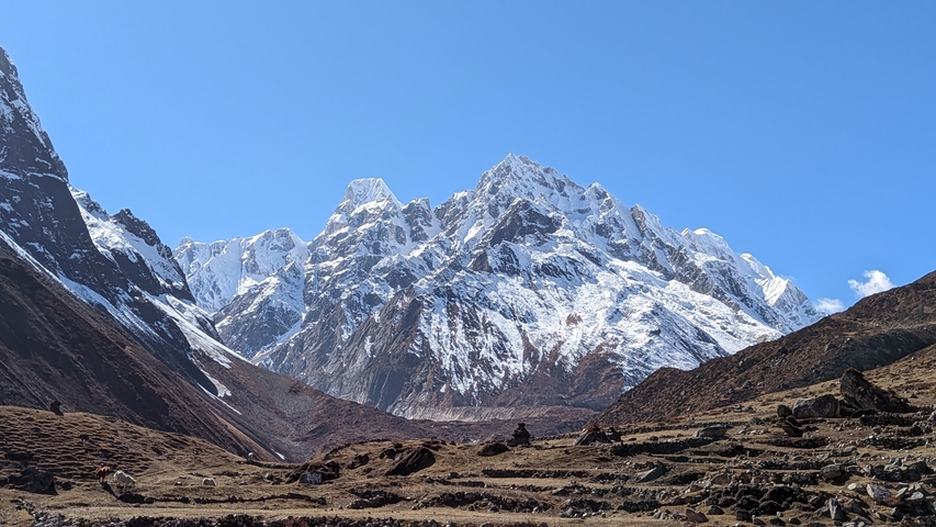 Scenic view of rugged snowy mountains under a clear sky.