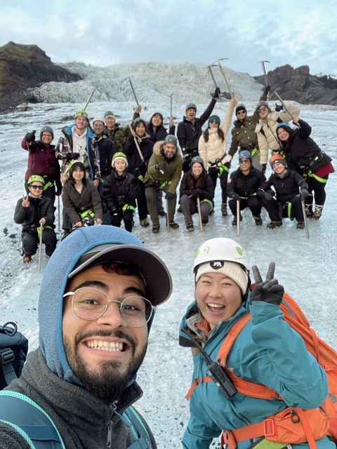Group of people posing for a photo in ice climbing gear.
