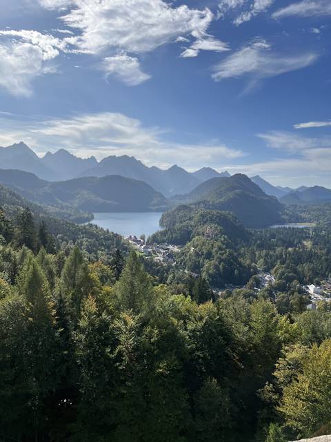 Panoramic view of a mountainous landscape with a lake.