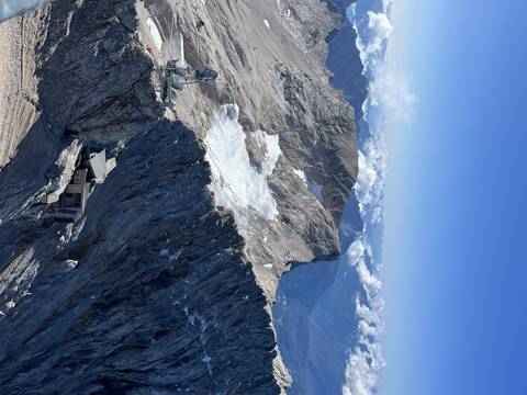 Snowy mountain landscape with a cable car station.