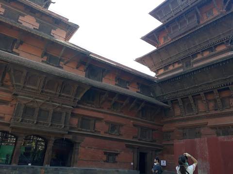       A traditional Nepali building with intricate wooden carvings.
  