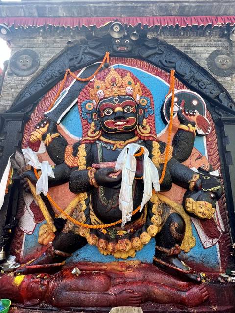       An intricate statue of a deity with multiple hands and decorations.
  