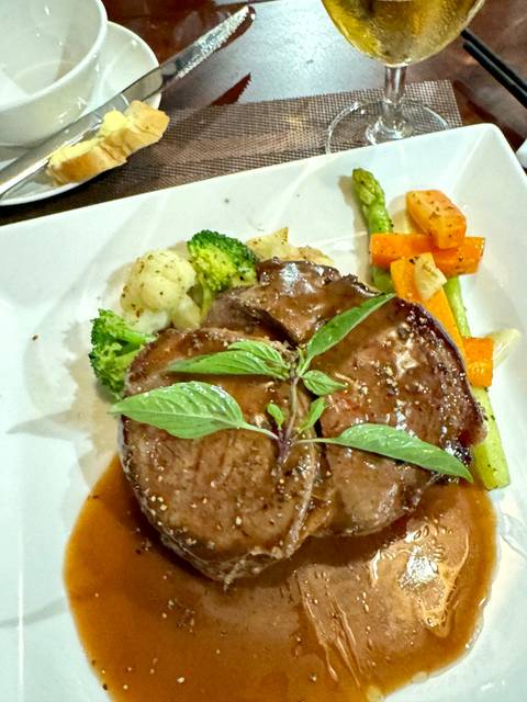       Plate of food with steak and vegetables.
  