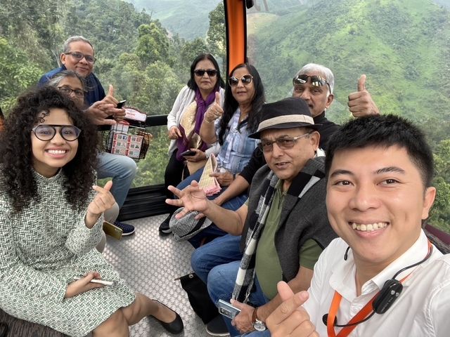 Group of people in a cable car with scenic views.