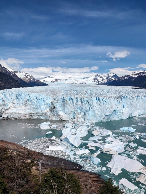       Perito Moreno Glacier with cloudy sky above.
  