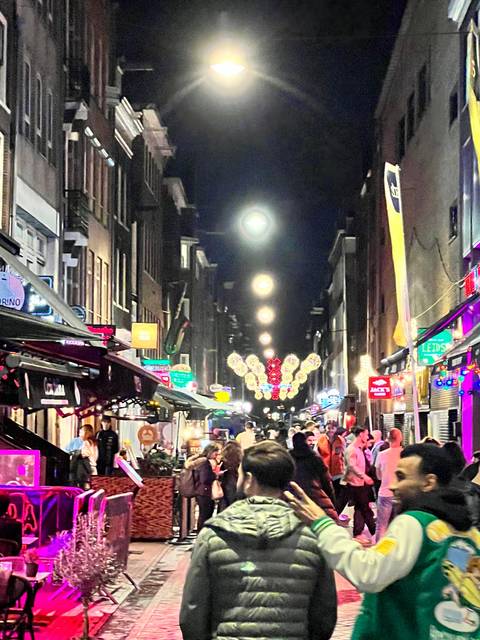       Upside-down view of a busy street with lights at night.
  