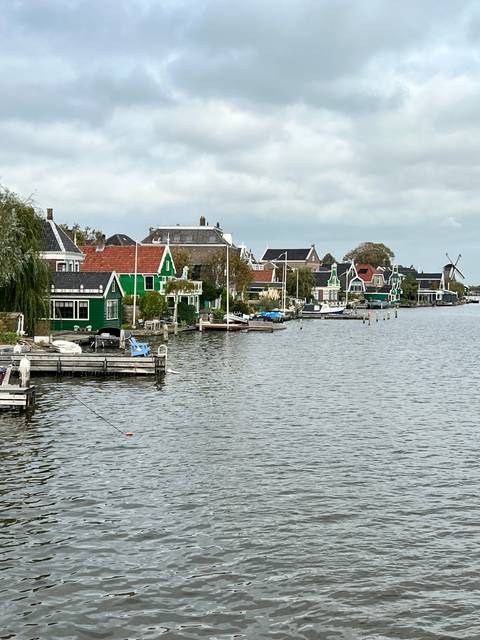       Upside-down view of a water channel with houses on the banks.
  