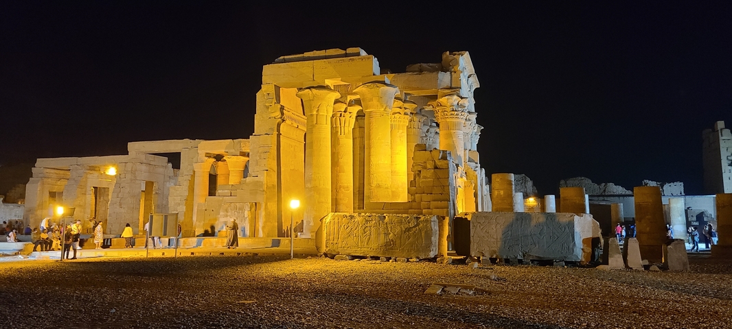       Illuminated ancient Egyptian temple at night.
  
