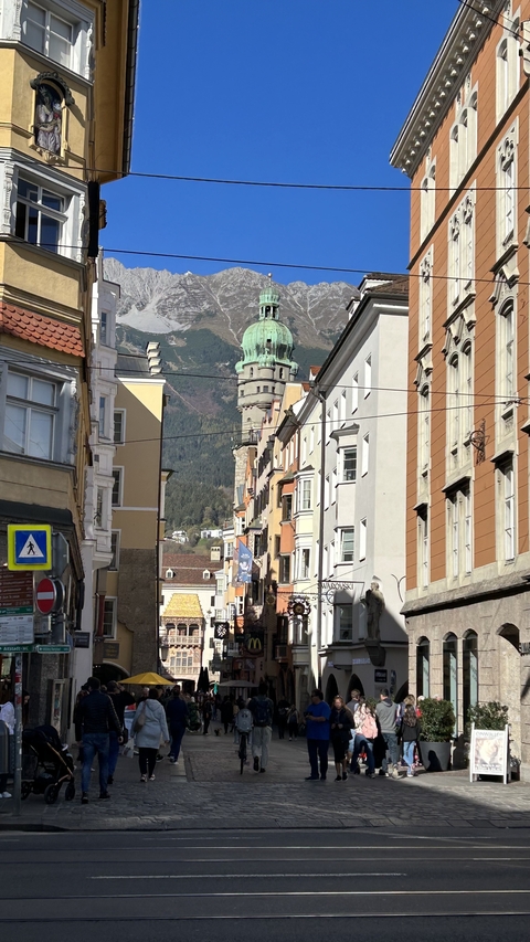      Street view of Innsbruck with mountains in the background.
  