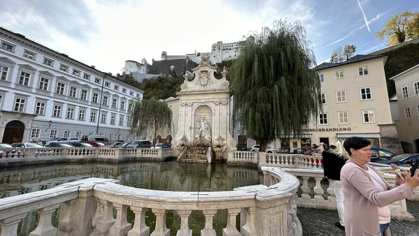       Fountain with fortress in the background.
  
