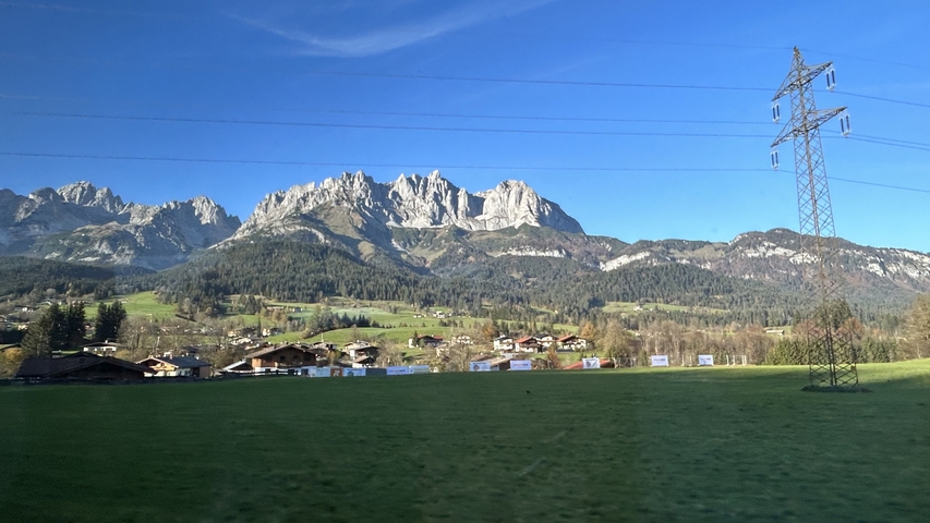 Dramatic mountain range with open fields.