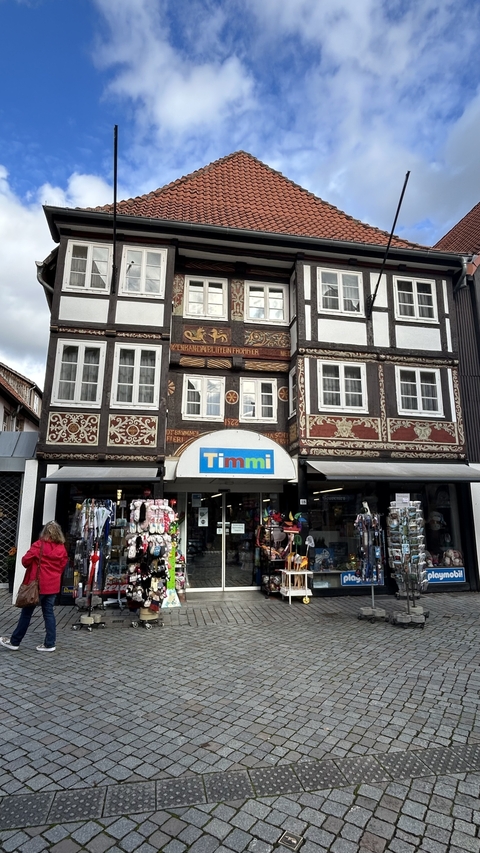       Decorated building facade with a shop entrance.
  