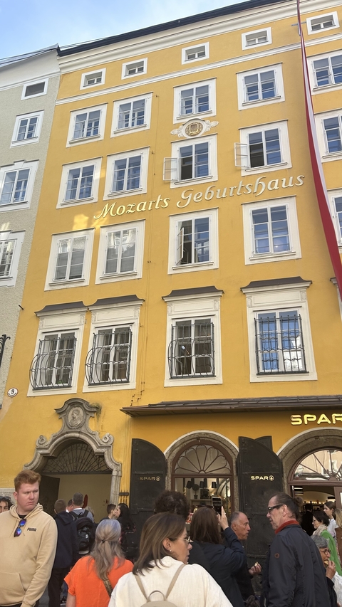 Yellow building facade with multiple windows.