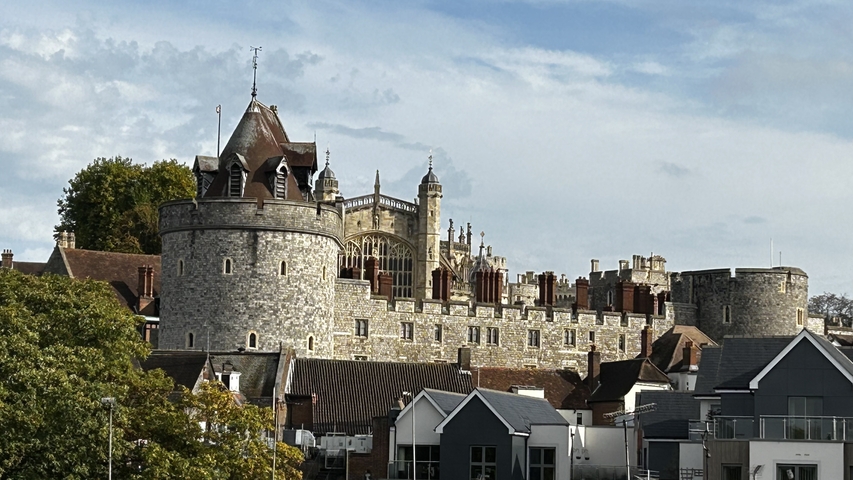       Historic castle with various buildings in the foreground.
  