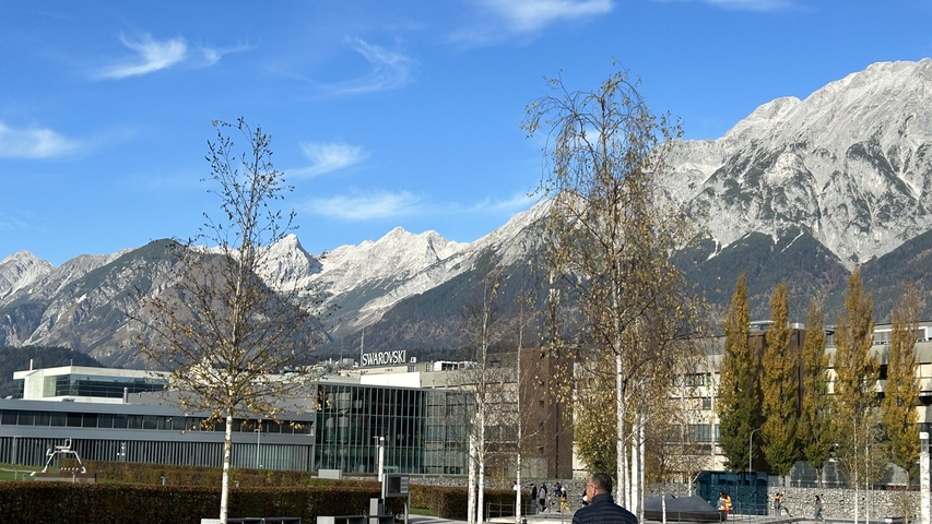       Mountainous landscape view with modern buildings.
  