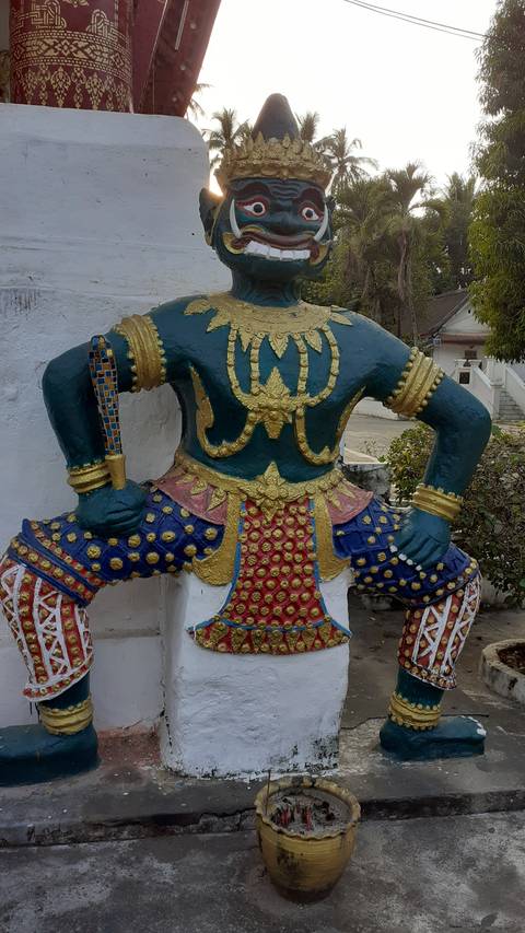      Colorful statue of a mythical figure in traditional attire.
  