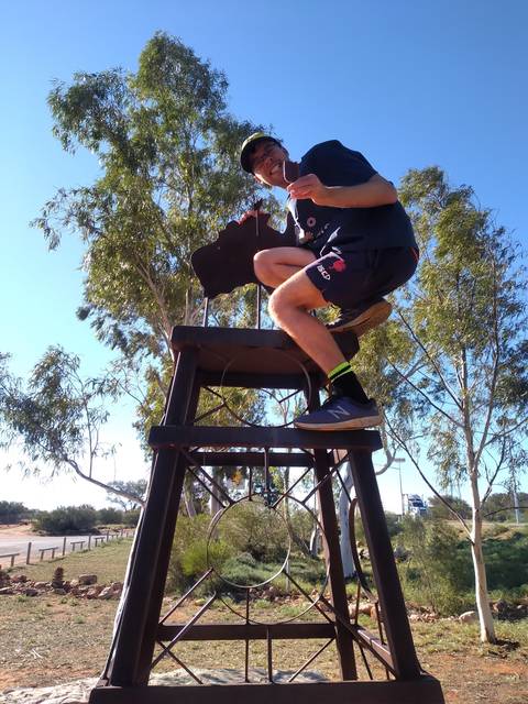       Person sitting on a large chair outdoors.
  