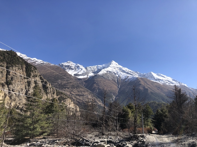 Snow-capped mountains with rocky landscape.