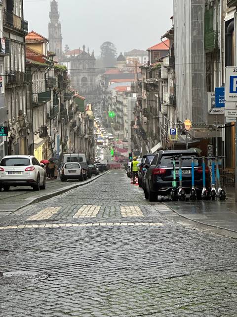 Street with cars and old buildings.