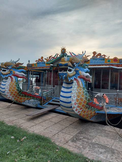 Colorful dragon boat on a pier.
