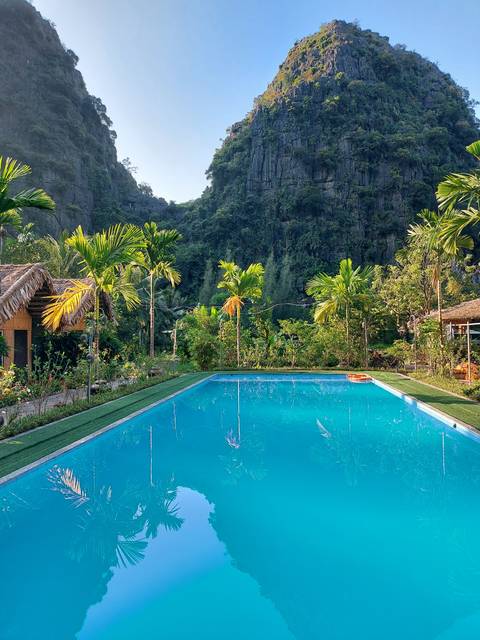 Infinity pool reflecting a limestone karst landscape.