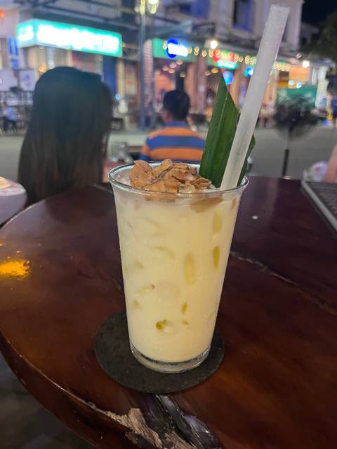       A refreshing iced beverage placed on a wooden table.
  