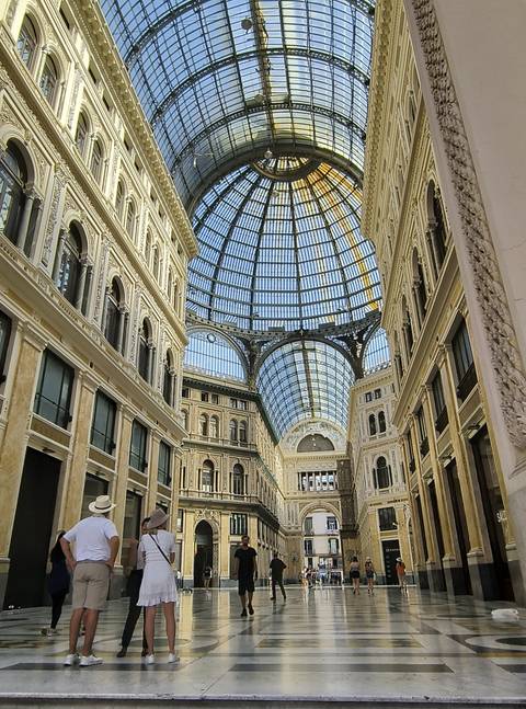       Interior of a glass-cabled arcade with intricate details.
  