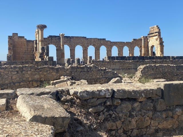       Ruins of an ancient stone structure with arches.
  