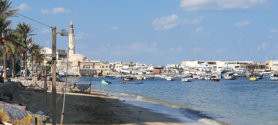 Seaside village with boats docked along the shore.