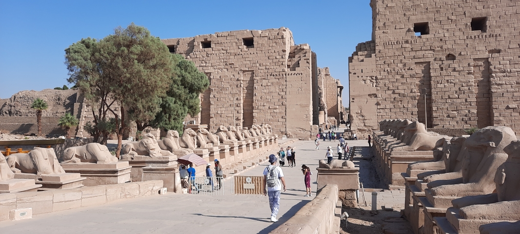Tourists walking through an ancient Egyptian temple.