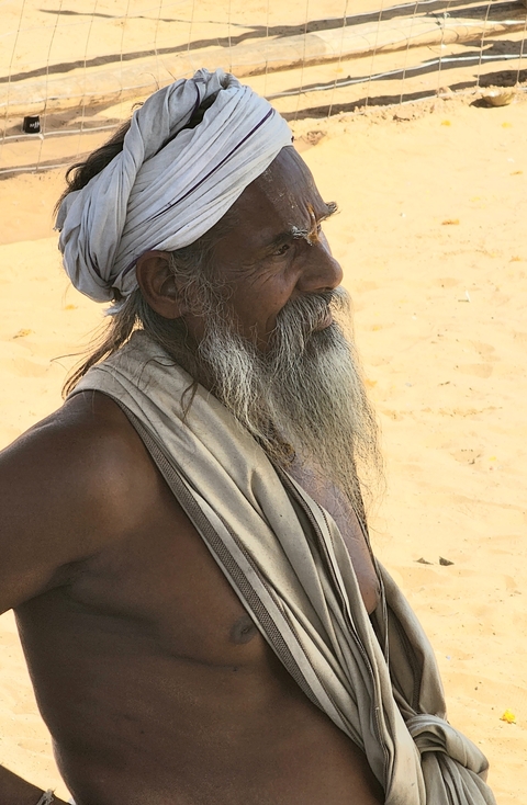       Close-up of an older man with a beard.
  