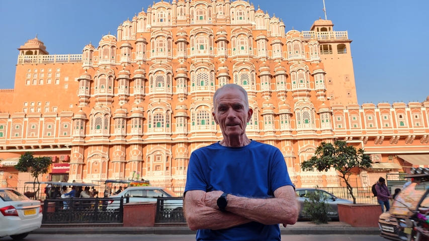       Man standing in front of the Hawa Mahal.
  