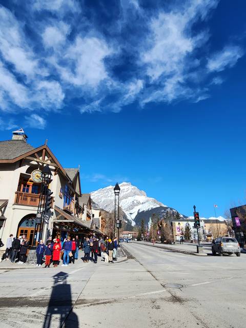 A snowy mountain town with shops and people.