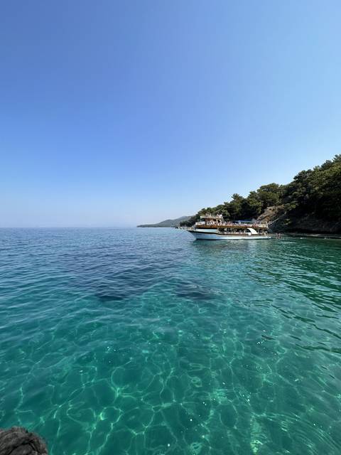       Clear blue sea with a distant coastline.
  