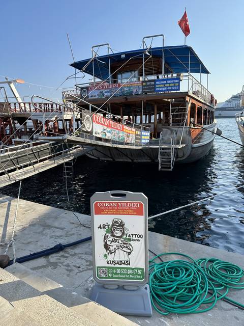       Moored boat with signage for a pub.
  