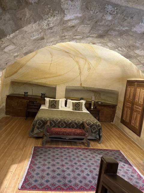       Decorative bed in a cave-like room.
  